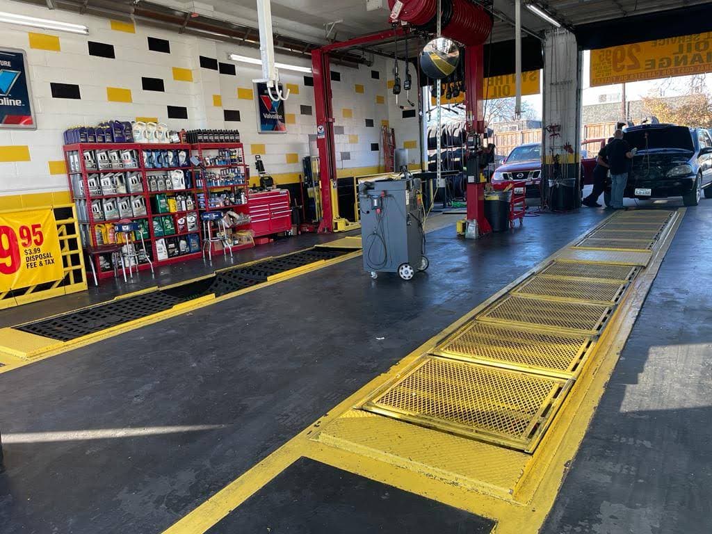 Technician pouring motor oil into an engine at Ten Minute Oil Change Plano