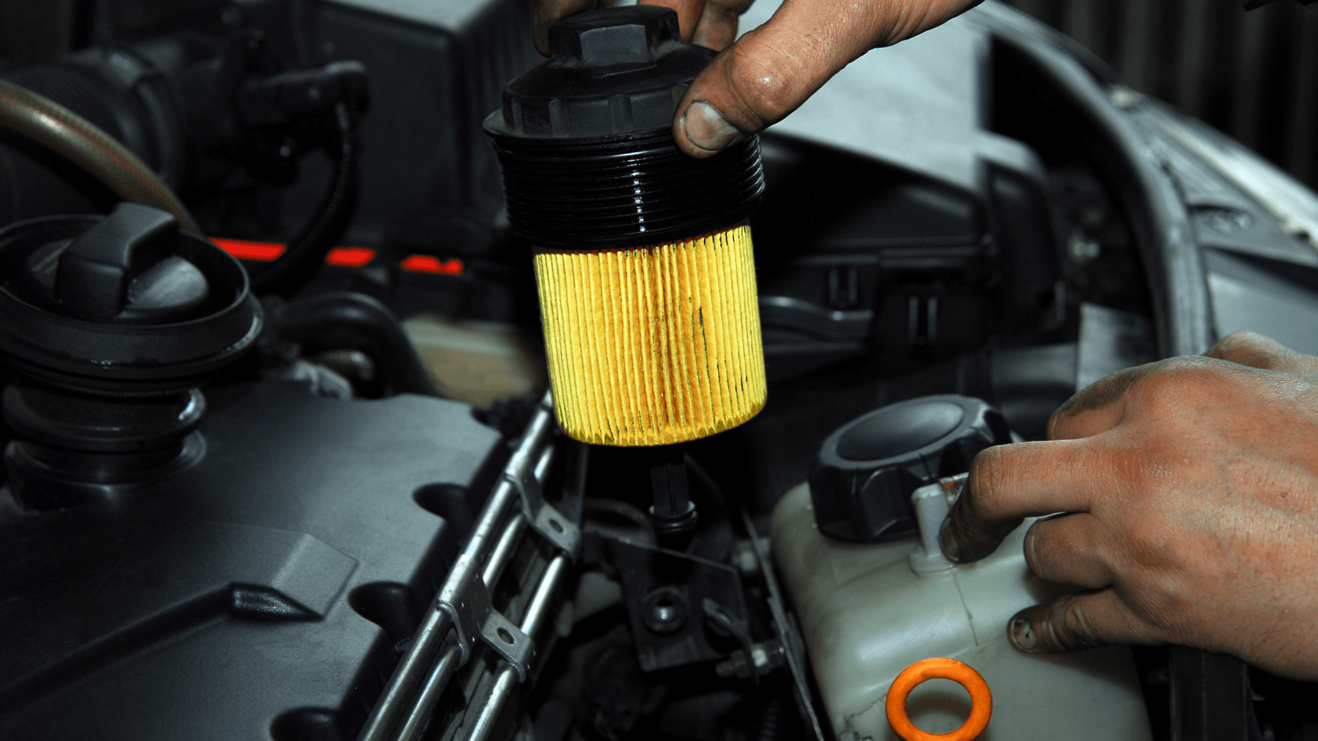 Mechanic working on the wheel of a vehicle on a lift in Plano